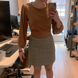 A cropped puffed sleeved top from Oak and Fort! The colour is a faded orange.